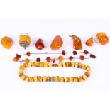 A collection of amber, Including two necklaces, a large loose bead, a key chain, a brooch and