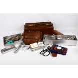 A collection of metal cased medical tools and equipment, including some in leather pouches, sold