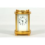 A gilt brass carriage timepiece, cast serpentine case with rectangular white enamel dial marked