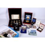 A mahogany cased set of 12 999 fine silver plated coins, with 999 fine gold coins to commemorate