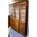 A mahogany breakfront library bookcase in George III style, with dentilled cornice and four doors