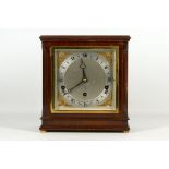 Mid 20th century Elliot mahogany cased chiming mantel clock, the square silvered dial with cast