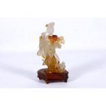 A late 20th Century agate carving of a lady, with hardwood stand.