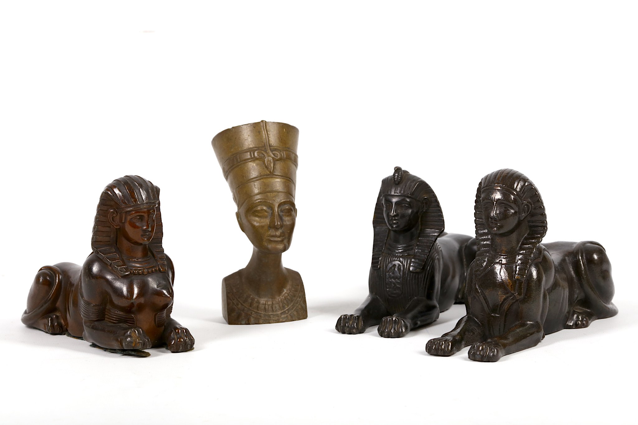 Three late 19th / early 20th Century, black painted metal sphinx, sold with bronze bust of Nefertiti