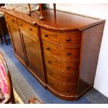 A large Victorian mahogany side cabinet, with bow ends bearing five drawers flanking two drawers and