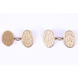 A pair of gold cufflinks, Double-sided each 9 carat gold oval plaque with engraved geometric