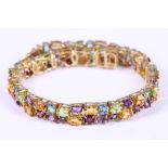 A multi gem-set bracelet, mounted in 9 carat yellow gold, UK import mark