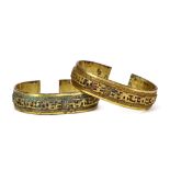 A PAIR OF CHINESE GILT BRONZE BRACELETS. Each with pierced rectilinear patterned designs, 9cm