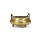 A CHINESE BRONZE CENSER. Qing Dynasty. The compressed globular body supported by three conical feet,