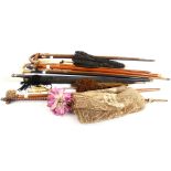 A collection of 12 various walking sticks and ladies umbrellas, to include hallmarked silver mounted