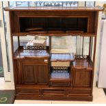 A 20th Century Chinese export rosewood and hardwood display cabinet, having carved gallery border