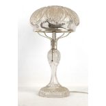 An early 20th Century bohemian crystal clear glass table lamp with diamond cut panels and diamond