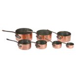 A graduated set of 7 copper saucepans with iron handles and tinned interiors. ( 7 )
