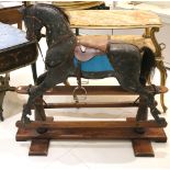 An early to mid 20th Century Stevenson style rocking horse, carved wood with black paint work, later