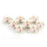 A set of 8 Hutschenreuter demitasse cups and saucers, moulded white body with puce floral