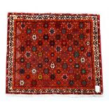 Four assorted oriental rugs to include an Afghan Balouch ( 55by35 ) , A Nain ( 125 by 85 ) , A Torba