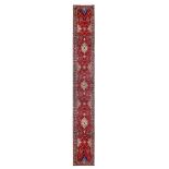 A FINE SAROUK RUNNER, WEST PERSIA approx. 15ft.11in. x 2ft.8in.(485cm. x 81cm.) The soft red field