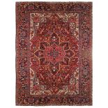 A HERIZ CARPET, NORTH-WEST PERSIA approx:12ft.9in. x 9ft.(390cm. x 274cm.) The field with angular