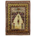 A FINE SILK SIVAS PRAYER RUG, TURKEY approx: 5ft.7in. x 4ft.1in.(170cm. x 124cm.) The ivory field