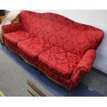 A 19th Century Italian 3 seater sofa, shaped back and front, covered in red damask.