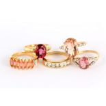 A group of five rings, variously set with pink gems and imitation gems, four with UK hallmarks for