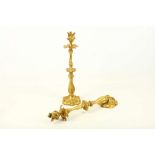 A pair of very early 20th Century ornate gilded bronze ormolu French candlesticks, with scrolling