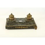 A large late 19th Century French Empire style, marble and gilded metal table inkwell, supported by