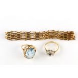 A small group of gold jewellery, comprising a gate-link bracelet, a synthetic spinel ring and a