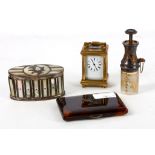 A miniature brass carriage clock, a white metal and mother of pearl oval box, an atomiser and a