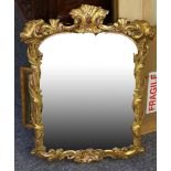 A 19th Century carved giltwood framed mirror, having scrolling foliate design and shell pediment, 64