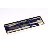 A cased Elizabeth II sterling silver-handled three-piece queen’s pattern carving set, Sheffield