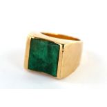 A gold and malachite dress ring, the square malachite plaque mounted in 9 carat gold, malachite