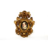 An oval portrait of Mary Queen of Scots, painted on porcelain and fitted with a carved giltwood