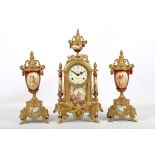 A late 19th / early 20th Century brass and porcelain clock garniture in neo-classical design. The
