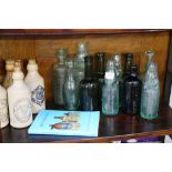 A collection of 33 Victorian and later glass and pottery bottles, including local examples by