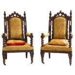 A pair of French Gothic revival oak armchairs, with well carved detail, upholstered seats and backs,