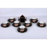 A set of 7 cups and 8 saucers by Fitz and Floyd Inc, in the 'Cloisonné Peony' patterna, together