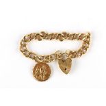 A 9 carat gold curb-link bracelet suspending a disc charm, UK hallmarks 1964