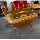 A 1960's Ercol drop flap dining table and four 'Contour' dining chairs, the chairs with original