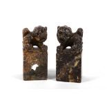 A pair of 19th Century Chinese carved stone lion dogs, on square bases carved as seals to bases,