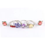 A group of jewellery including four gem-set rings mounted in 9 carat white gold and a pair of 18ct