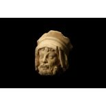 A FRENCH GOTHIC LIMESTONE HEAD, PROBABLY 13TH / 14TH CENTURY the male figure wearing a head dress,