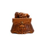 A 19TH CENTURY CARVED ROOTWOOD SNUFF BOX the box with hinged lid surmounted by a carved model of a