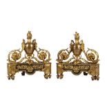 A PAIR OF 19TH CENTURY FRENCH LOUIS XVI STYLE GILT BRONZE CHENETS / ANDIRONS each decorated with a