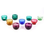 A collection of nine coloured glass finger bowls, 19th Century and later, to include two wrythen