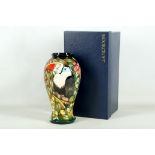 A modern Moorcroft pottery baluster shaped vase with everted rim, tube-lined with exotic birds in