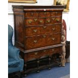 An 18th Century feather-banded figured walnut chest on stand, with concealed cushion drawer, on