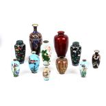 A collection of various Oriental, mostly Japanese, cloisonné vases enamelled with flower heads,