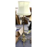 An early 20th Century heavy brass standard lamp of neo-classical design, supported by three