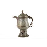 A 19th century Indo/Persian flagon. All over incised design and a pierced base Height 40 cms.